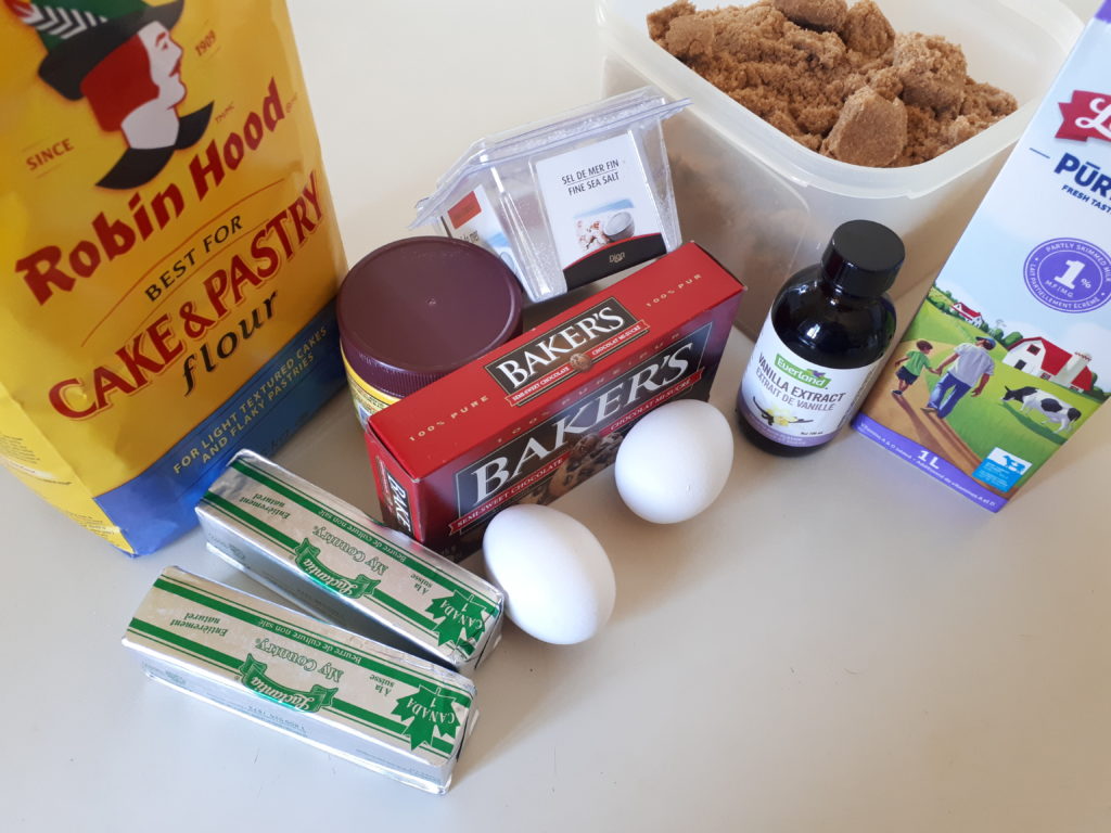 the ingredients for a homemade chocolate cake, grouped together on a kitchen counter
