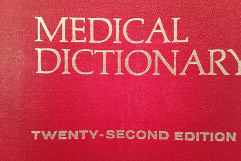 the leather-bound cover of an old medical dictionary