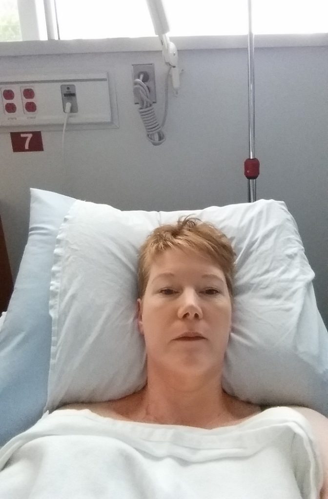 a woman in a post-surgery hospital bed