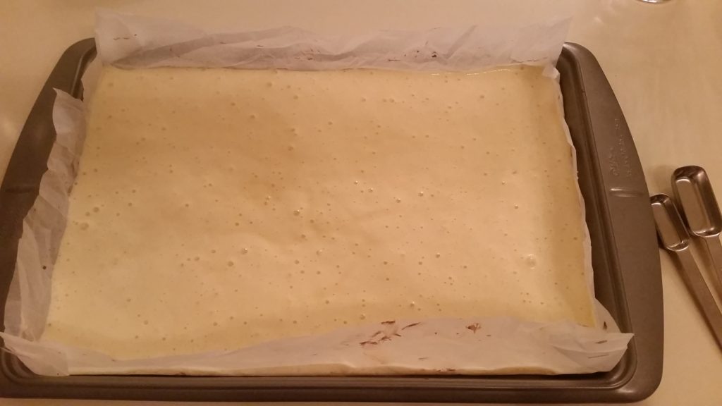 batter for a chocolate log cake, in a baking dish
