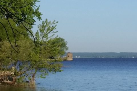 the ruins of an old fort on the shore of a lake