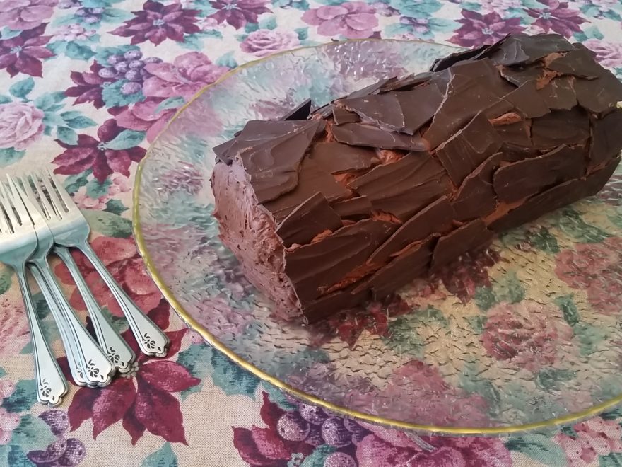 a chocolate log cake on a serving platter