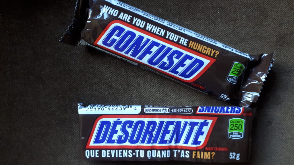 Two Snickers bars, with special labels saying Confused in English and Disoriented in French (Désorienté).