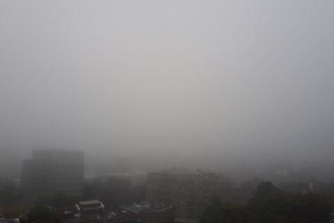 fog enveloping the city of Montreal, in a photo taken from the mountainside Montreal General Hospital
