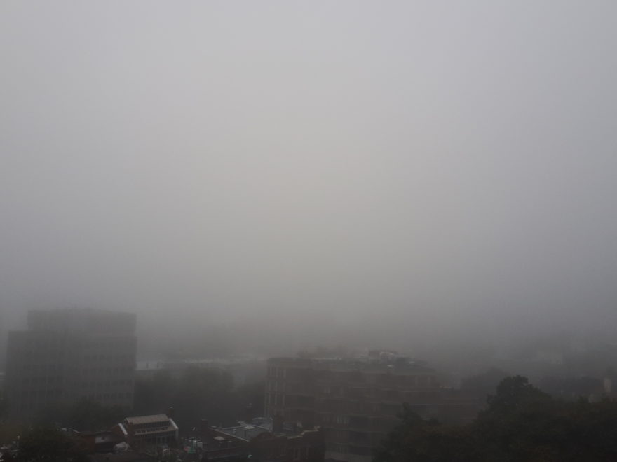 fog enveloping the city of Montreal, in a photo taken from the mountainside Montreal General Hospital