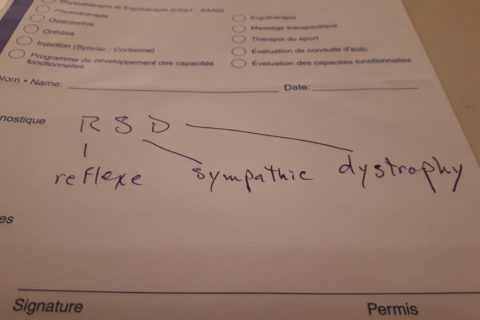 a physician's prescription note, with the handwritten words "reflexe sympathic dystrophy" instead of the correct reflex sympathetic dystrophy