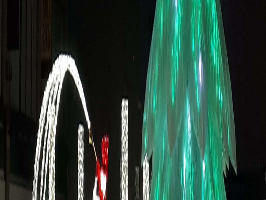 A lightshow featuring a trumpet-playing snowman and a Christmas tree, as part of the LuminoThérapie festival