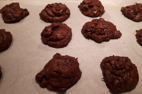 freshly-baked triple dark chocolate cookies, still on the baking pan