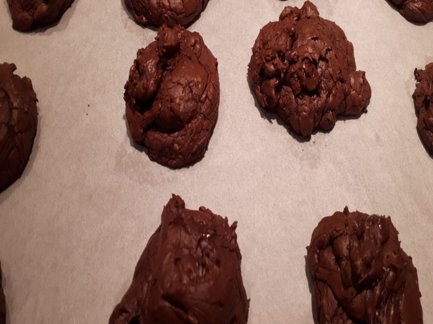 freshly-baked triple dark chocolate cookies, still on the baking pan