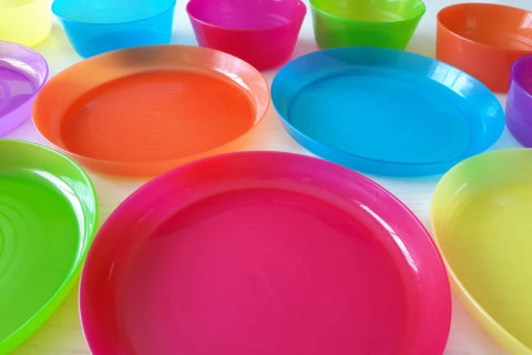 a matched set of small plastic plates and bowls