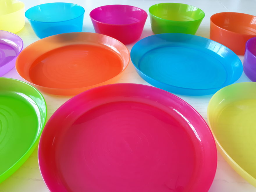 a matched set of small plastic plates and bowls