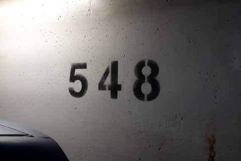 the number "548" stencilled onto a cement wall