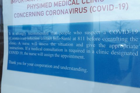 A COVID-19 sign outside a medical clinic