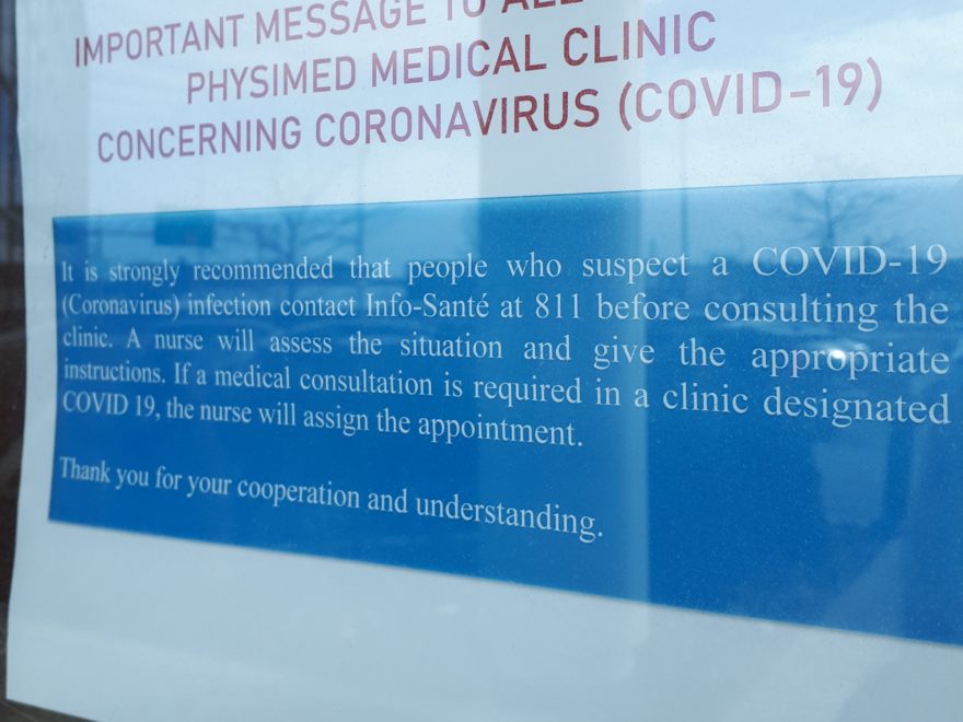 A COVID-19 sign outside a medical clinic