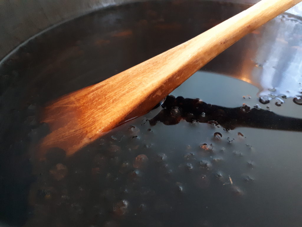 a pot of dried elderberries and water, on the stove