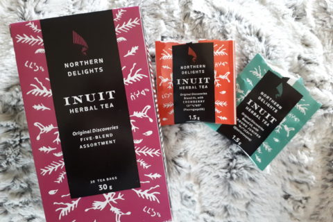 A boxed assortment of Canadian "Inuit Herbal Tea", made by "Northern Delights", against a snowy background