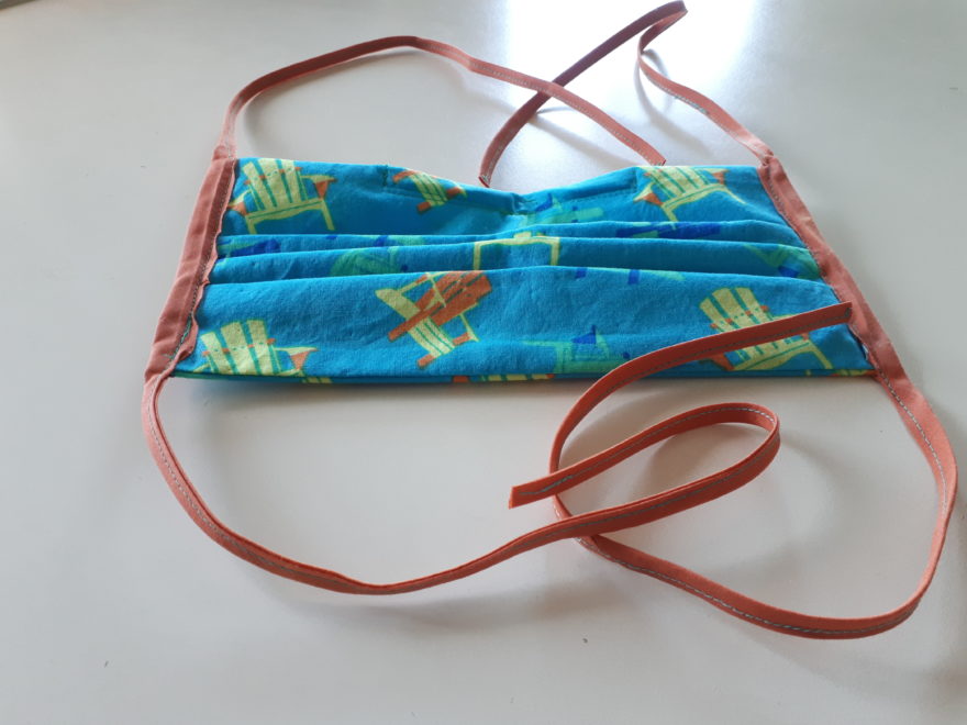 a handmade face mask, with ties to be attached at the back of the wearer's head