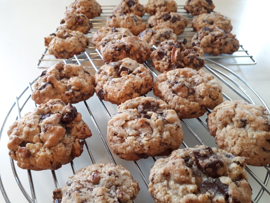 freshly-baked homemade chocolate chunk cookies on a cooling rack