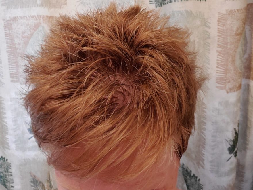 the top of a woman's head, showing a very short and choppy haircut