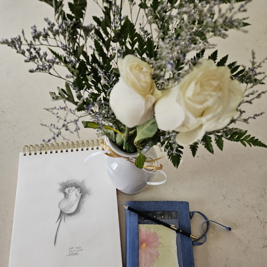 A pencil sketch of a single rose, beside a vase holding two roses
