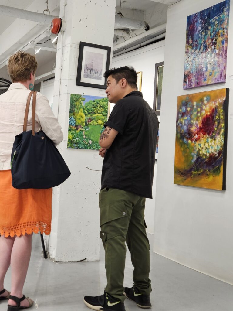 Sandra Woods chatting with another artist at the Galerie BOA Gallery