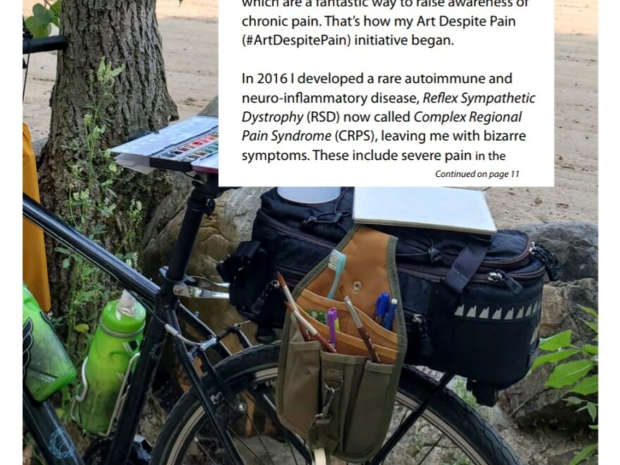 A bicycle being used as an easel for watercolour painting, on a beach