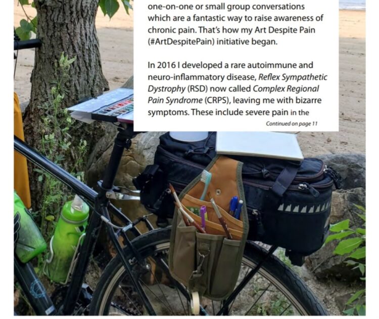 A bicycle being used as an easel for watercolour painting, on a beach