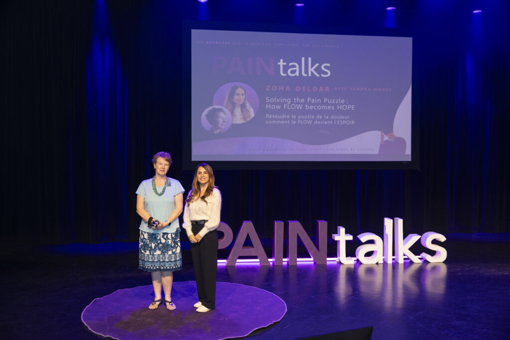 Photo of Dr Zoha Deldar and Sandra Woods onstage at PAINtalks 2024, Nov 7, 2024 at The Gesù in Montréal