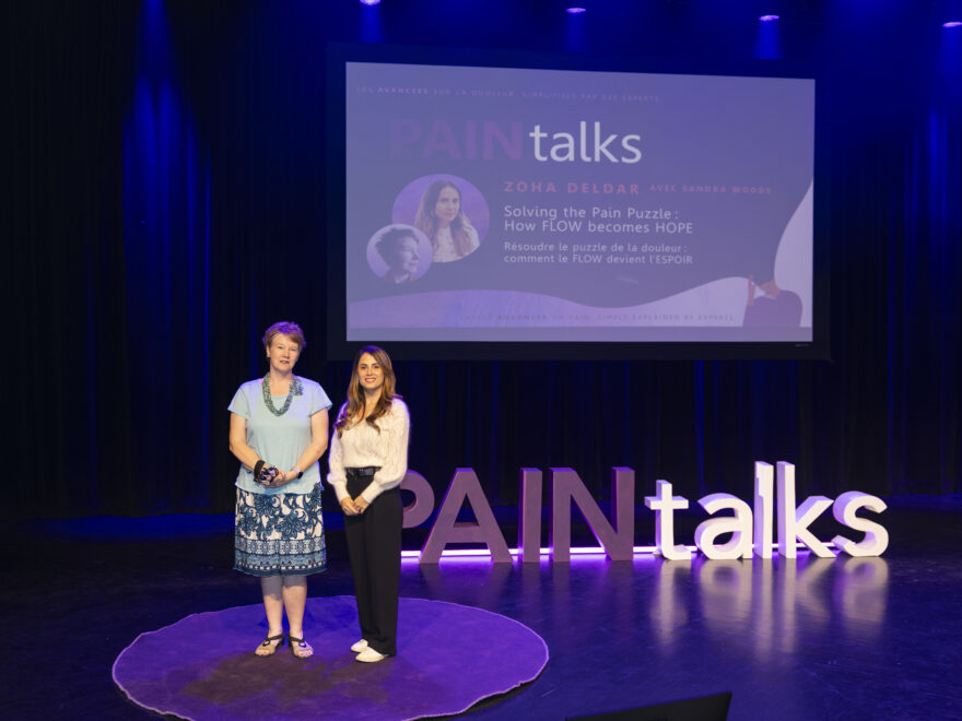 Photo of Dr Zoha Deldar and Sandra Woods onstage at PAINtalks 2024, Nov 7, 2024 at The Gesù in Montréal