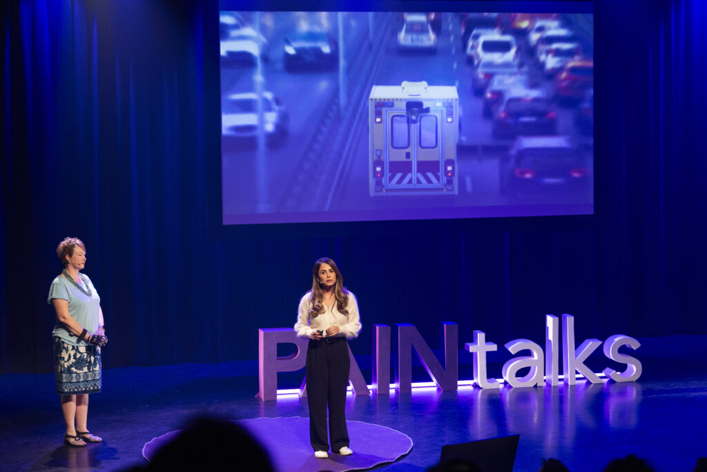 Photo of Dr Zoha Deldar and Sandra Woods onstage at PAINtalks 2024, Nov 7, 2024 at The Gesù in Montréal