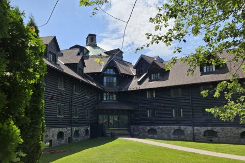 A view of two arms of the hexagonal Château Montebello hotel, built of logs in 1930, with one of the many guest entrances where the two arms or branches of the building meet.
