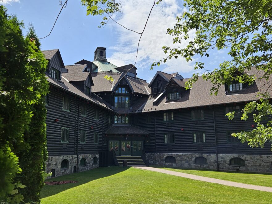 A view of two arms of the hexagonal Château Montebello hotel, built of logs in 1930, with one of the many guest entrances where the two arms or branches of the building meet.